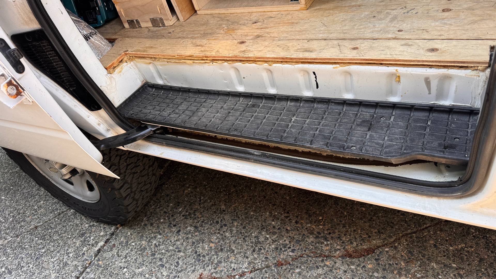 Door open, lower track exposed — inspection view for debris, polished wear points, and track-end stop condition.